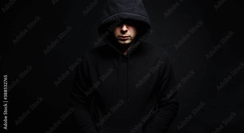 Boy in a hooded sweatshirt. Male portrait