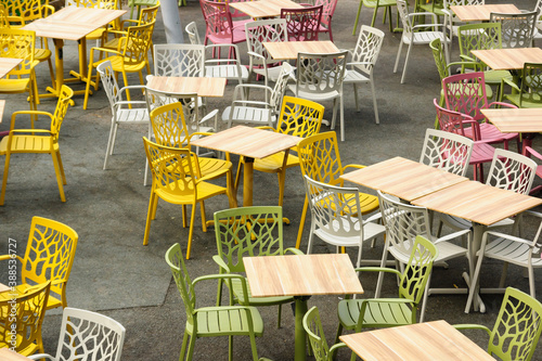 Empty chairs and tables in an outdoor dining area photo