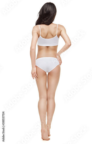 Fitness young woman with a beautiful body on white background