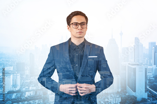 Canvas Print Young handsome businessman in suit and glasses dreaming about new career opportunities after MBA graduation