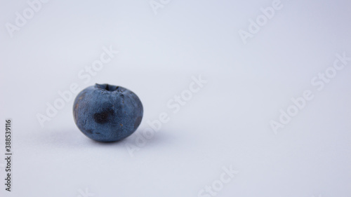 Close-up of ripe juicy blueberries on a white background.