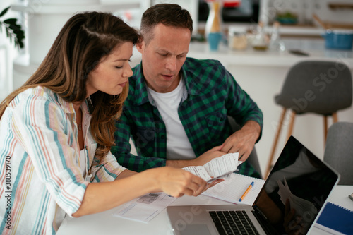 Husband and wife preparing bills to pay. Young couple having financial problems