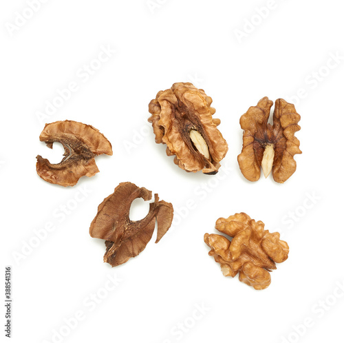 shelled walnuts and partition isolated on white background, top view
