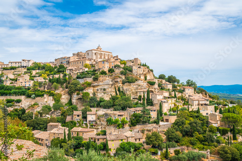 Old Provencal village on the cliff with houses of stone and plenty of greenery - Gordes, Provence, France