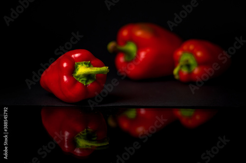 Red peppers on black background