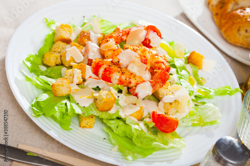 Caesar salad on plate at restaurant. High quality photo