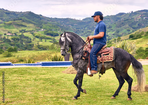 Man riding a horse in farm outdoors. Man on horse galloping outdoor. Life style. © ValenPh