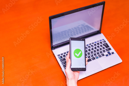 smart phone verification and laptop computer photo