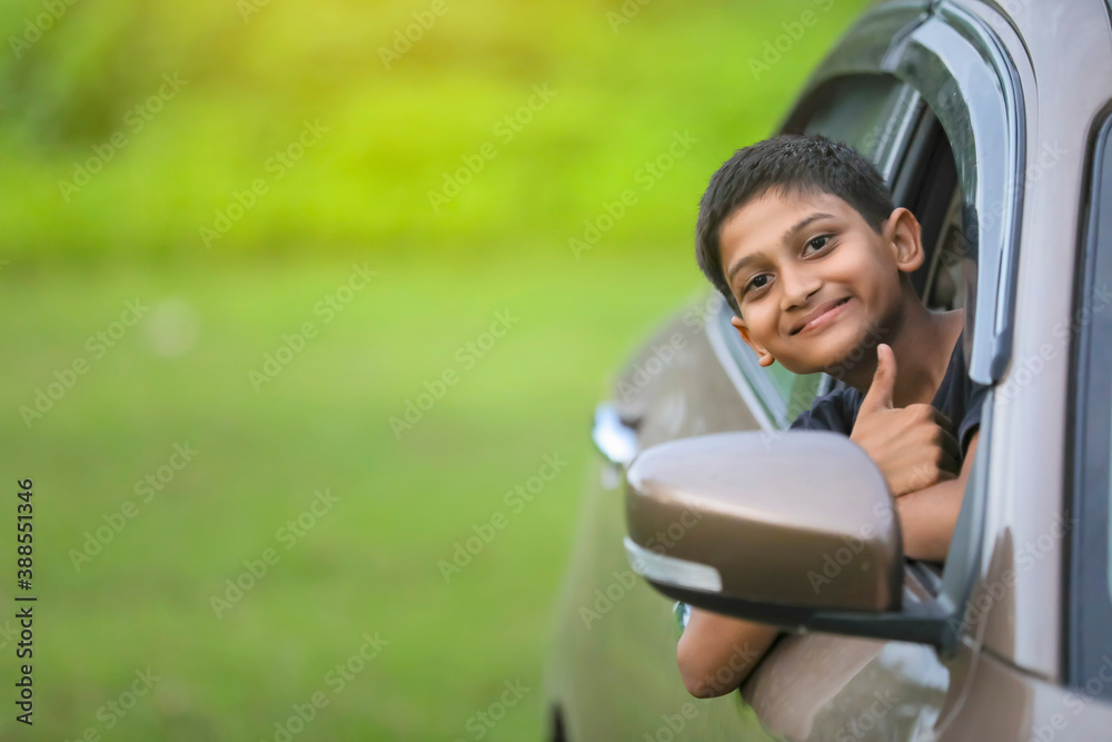 Cute Indian child showing face expression in car Cute Indian child showing face expression in car
