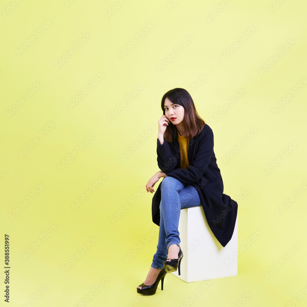 young asian woman sitting on the blank empty box