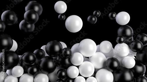 Black and white balls fall into a pool or screen on a black background. Spheres fill the volume. 3D render. © garrykillian
