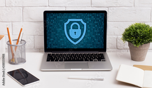Laptop on table with padlock icon on the screen