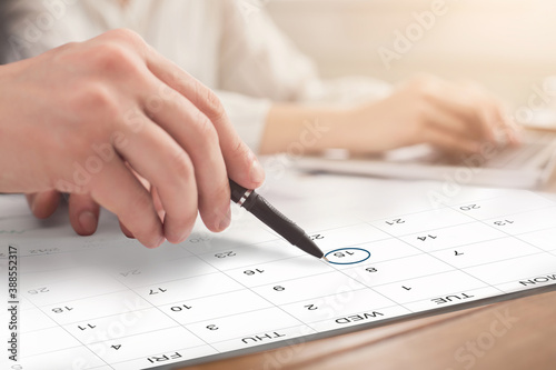 People In Office Planning Business Schedule, Marking Date In Calendar At Workplace