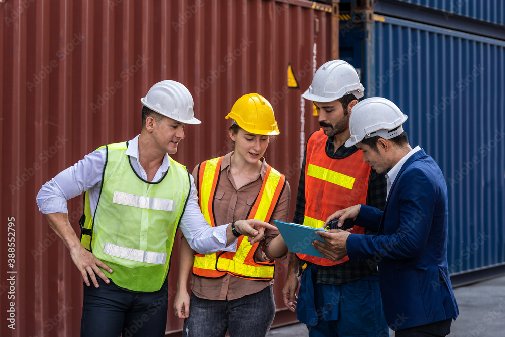 Group of staff worker standing and checking the containers box from cargo ship for export and import Group of staff worker standing and checking the containers box from cargo ship for export and import