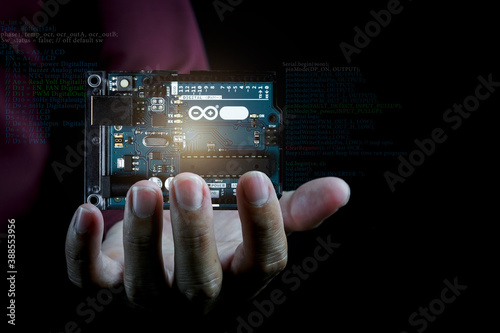Arduino controller board element photo in dark background with infographic details.