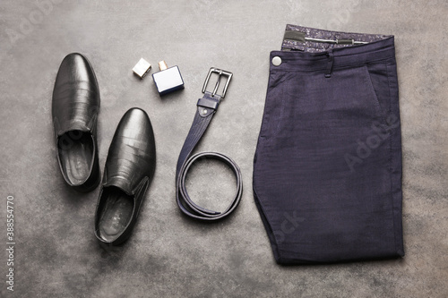 Classic blue men's trousers with black leather shoes and a belt