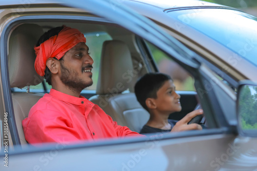young indian farmer and little child with car © PRASANNAPIX