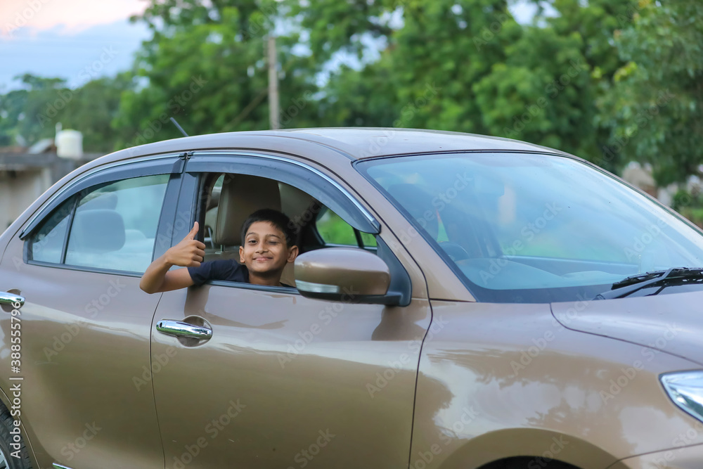 Cute Indian child showing face expression in car Cute Indian child showing face expression in car