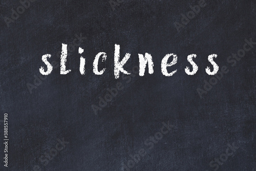 College chalk desk with the word slickness written on in photo