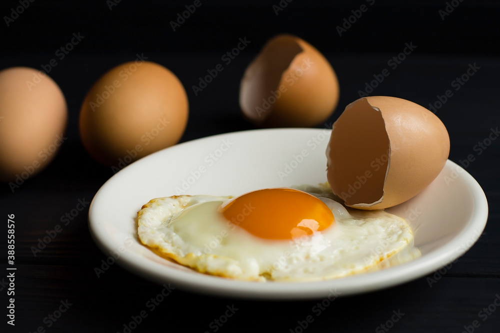 fried egg, eggshells on a white plate fried egg, eggshells on a white plate