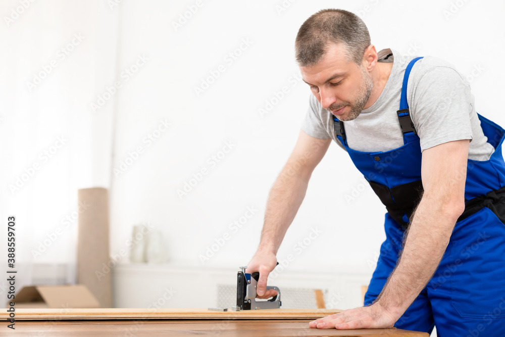 Professional Carpenter Working Using Staple Gun Making Furniture Standing Indoors Professional Carpenter Working Using Staple Gun Making Furniture Standing Indoors