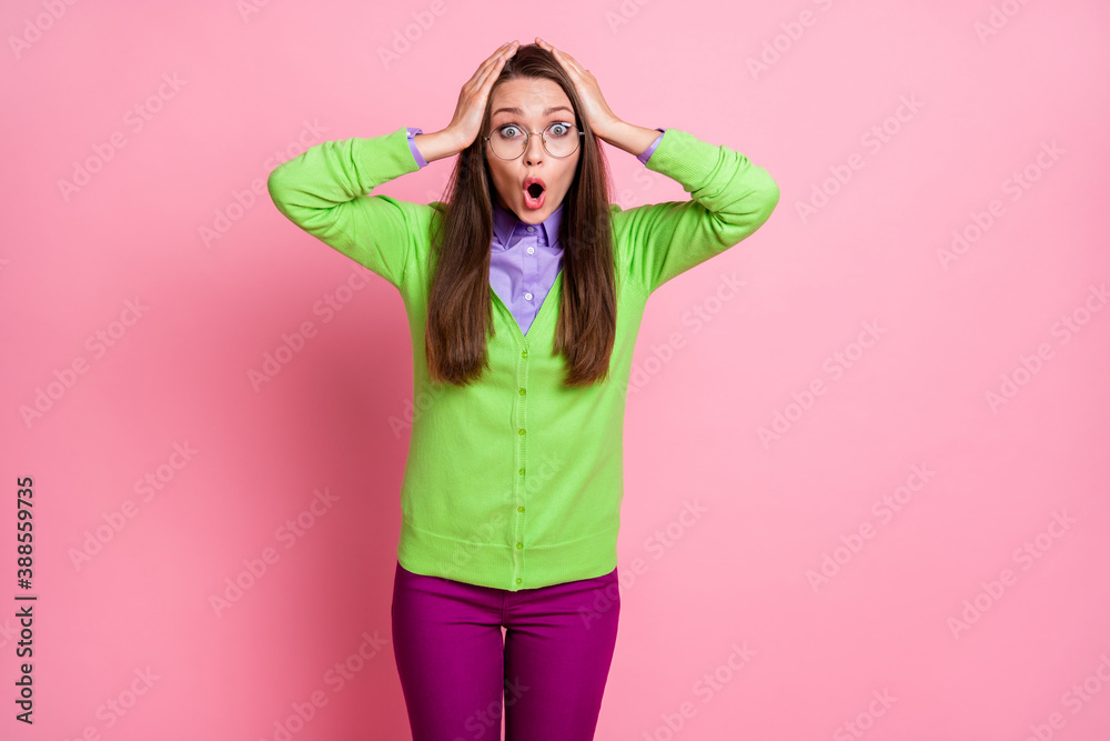 Portrait of voiceless stunned girl touch hands head impressed scream isolated over pink color background Portrait of voiceless stunned girl touch hands head impressed scream isolated over pink color background