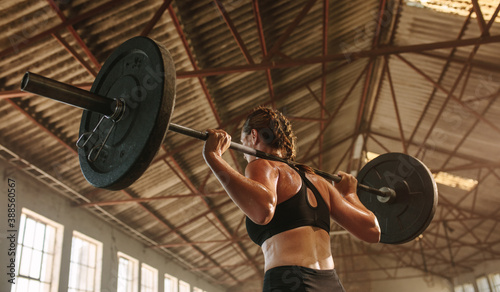 Принти на полотні Strong woman exercising with barbell