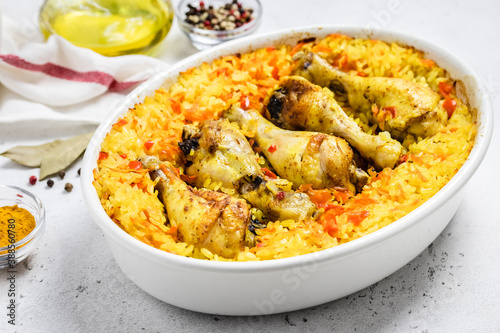 Yellow turmeric chicken curry rice casserole in baking dish. Space for text.