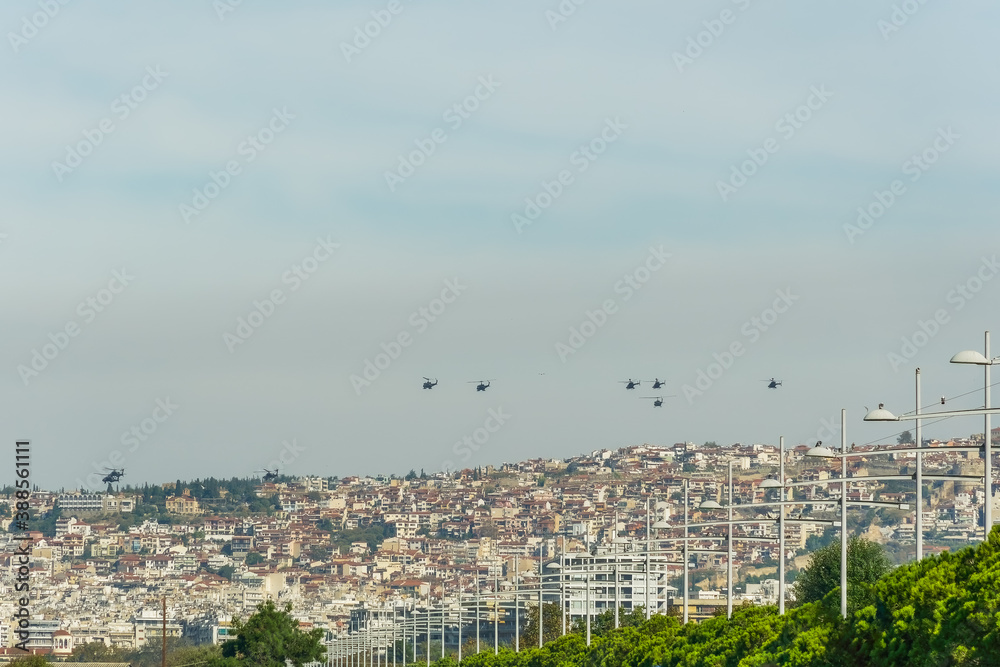 Military helicopters flying above a city. Greek Air Force AH-64 Apache, Kiowa Warrior & Huey UH-1H on formation in Thessaloniki at October 28 commemorating Hellenic no against Italian 1940 ultimatum. Military helicopters flying above a city. Greek Air Force AH-64 Apache, Kiowa Warrior & Huey UH-1H on formation in Thessaloniki at October 28 commemorating Hellenic no against Italian 1940 ultimatum.