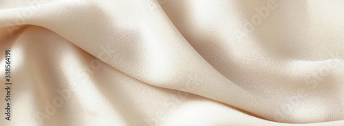 Beige silk texture background . Beautiful soft crumpled silk fabric wedding backdrop. copy space