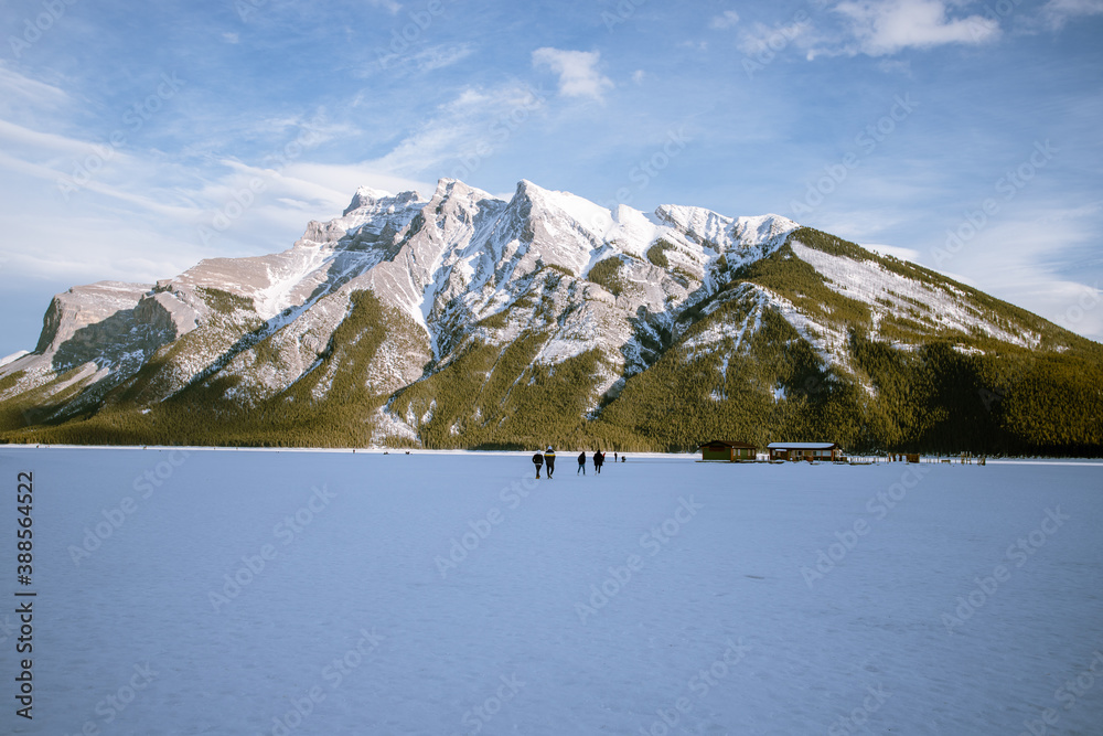 Beautiful snowy mountains backdrop a frozen lake