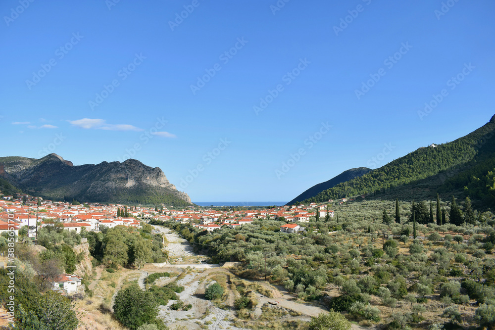 Panoramic view of Leonidio village and Parnonas Mountain at South Kynouria, Arcadia, Peloponnese, Greece. Blue sky, greek traditional village and mountain