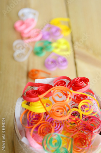 Colorful heart curling paper on wooden
