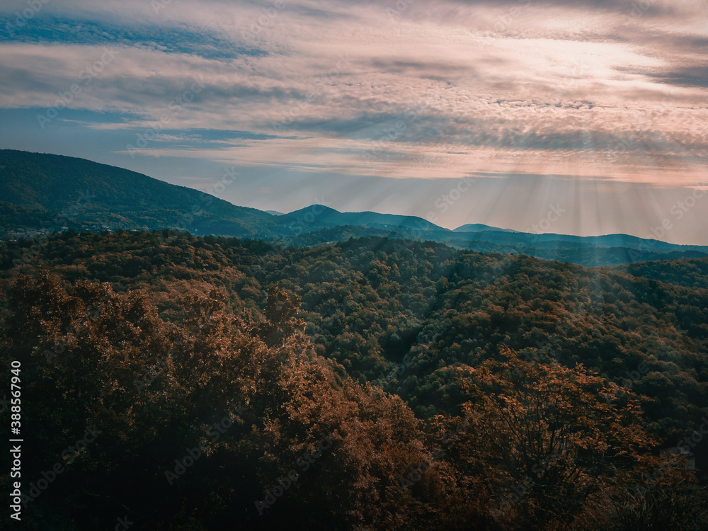 Mountains of the North Caucasus on an autumn day under a cloudy blue sky with the sun shining through. Mountains of the North Caucasus on an autumn day under a cloudy blue sky with the sun shining through.