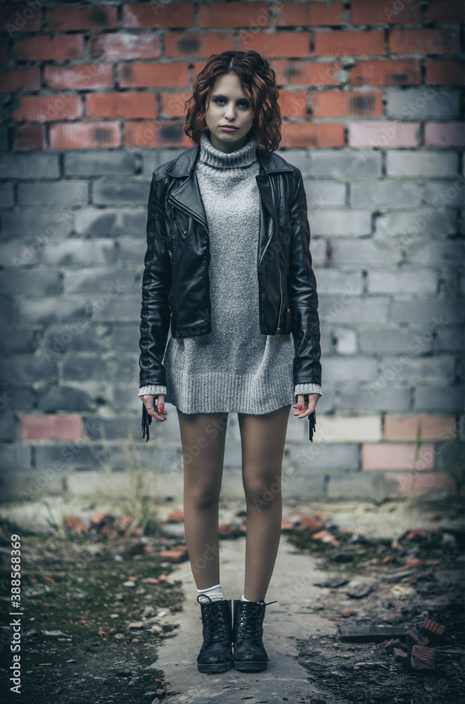 Woman in sweater and leather jacket Woman in sweater and leather jacket