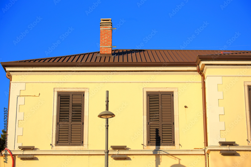 old Yellow house with a roof in the city old Yellow house with a roof in the city