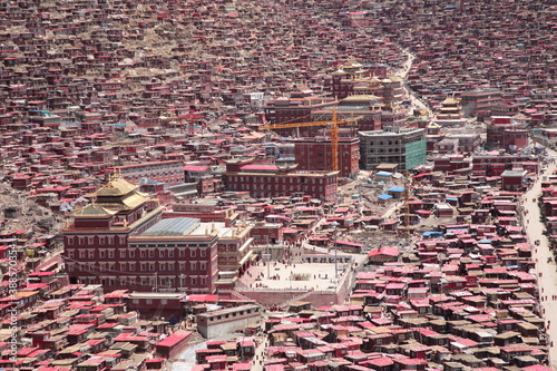 View of The Serta Larung Five Science Buddhist Academy and its red surrounding log cabins in Sertar county, Garze Tibetan Autonomous Prefecture, Sichuan, China.  photo