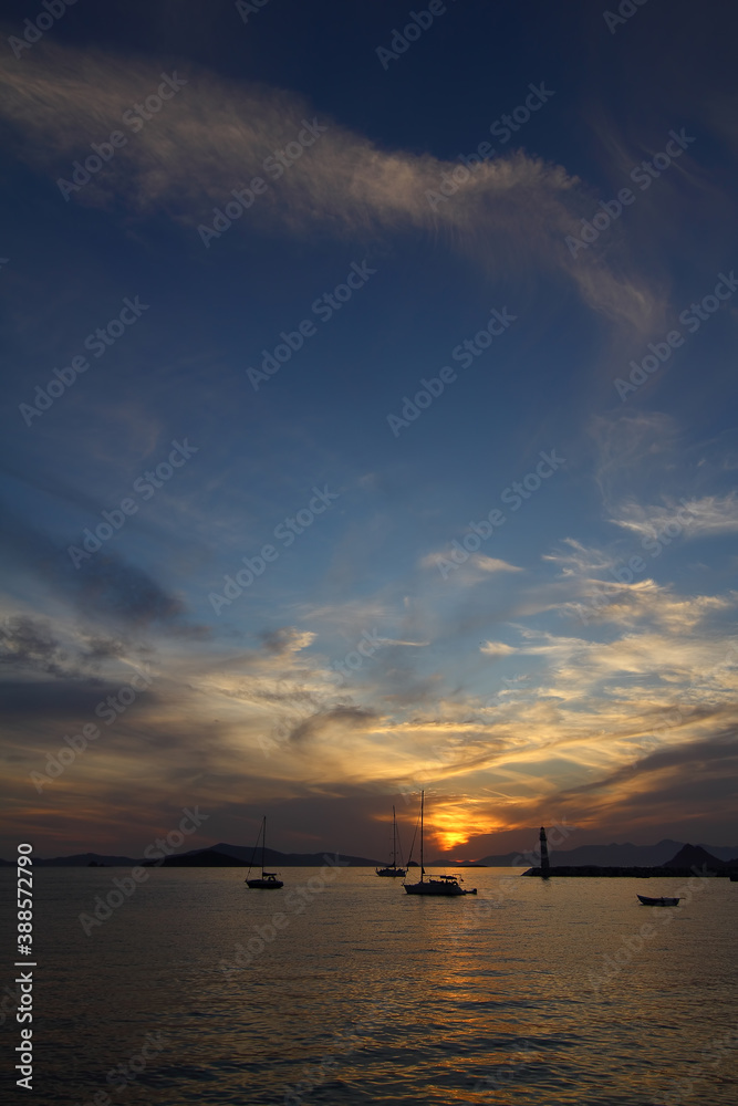 Seascape at sunset. Lighthouse on the coast. Seaside town of Turgutreis and spectacular sunsets Seascape at sunset. Lighthouse on the coast. Seaside town of Turgutreis and spectacular sunsets
