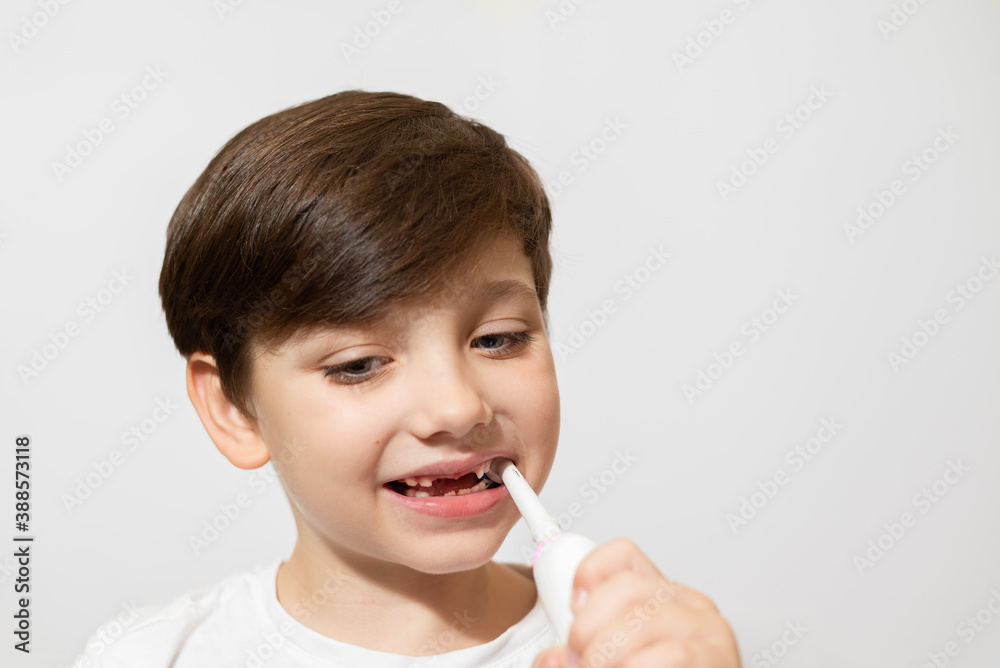 Cute little boy brushing teeth, isolated on white Cute little boy brushing teeth, isolated on white