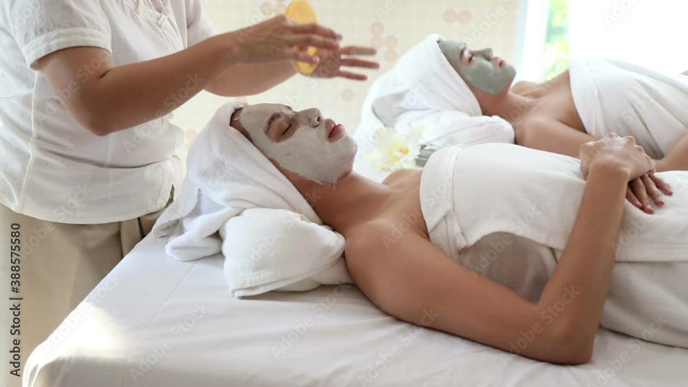 beautician use sponge to wipe facial mask around eyes of young Asian women face after fill up, vdo by handheld beautician use sponge to wipe facial mask around eyes of young Asian women face after fill up, vdo by handheld