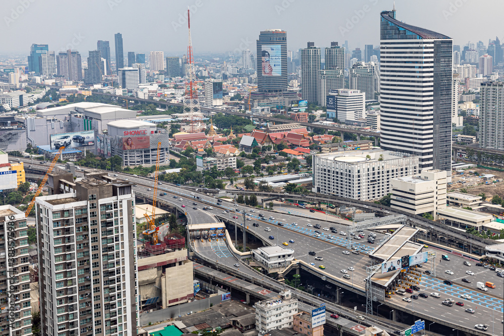 Obraz premium BANGKOK, THAILAND - SEPTEMBER-23-2020 : Aerial view of busy cars with traffic jam in the rush hour on highway road street on bridge in downtown, urban city in Asia. Intersection junction.
