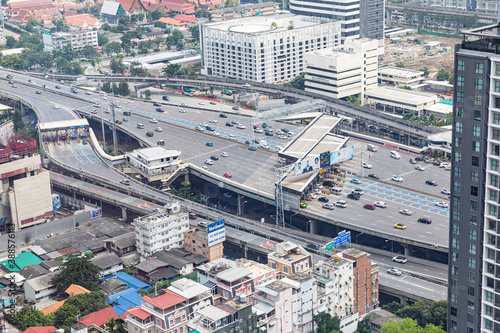 BANGKOK, THAILAND - SEPTEMBER-23-2020 : Aerial view of busy cars with traffic jam in the rush hour on highway road street on bridge in downtown