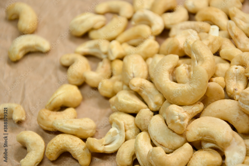 Cashew nuts. Cashew kernels. Clean organic nuts on retro paper background. Organic healthy food. Cashew nuts. Cashew kernels. Clean organic nuts on retro paper background. Organic healthy food.
