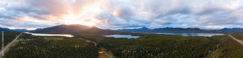 Panoramic View of Scenic Lakes surrounded my Mountains and Forest at Sunset in Canadian Nature. Aerial Drone Shot. Yukon, Canada.