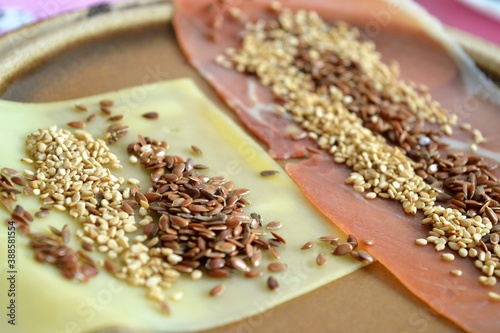 Serrano ham slice and cheese slice with sesame seeds and flax on top for breakfast or a snack © Fekete Images