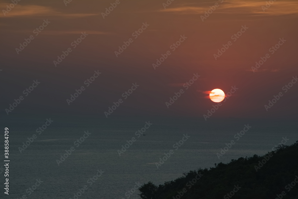 Fototapeta premium Growing red cloud over blue sea in sunset time