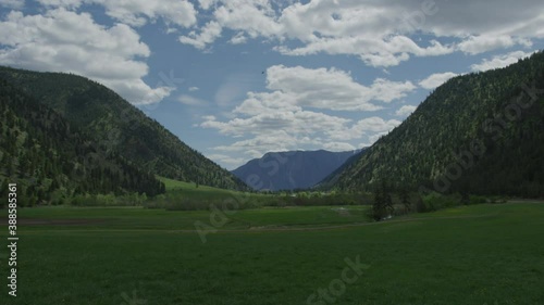 Wallpaper Mural 4K Time lapse of field with mountains with green fields, white clouds and ranch Torontodigital.ca