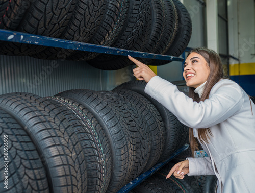 A female choosing tires in the garage