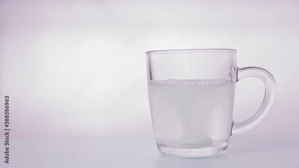 Effervescent tablet dissolves in a glass of water bubbles Effervescent tablet dissolves in a glass of water bubbles