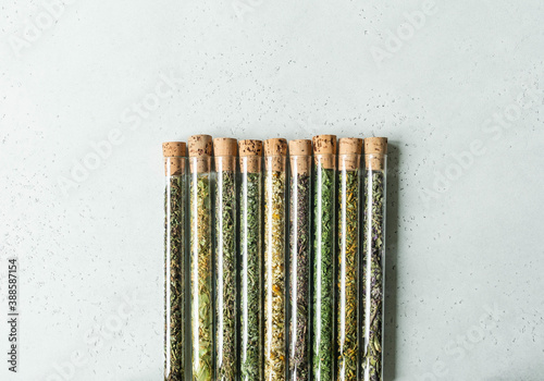Various dry healthy herbs, plant flowers for brewing herbal tea in glass test tubes